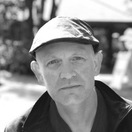 Headshot of Adam Brazier.